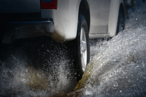 vehicle driving over a large puddle of water