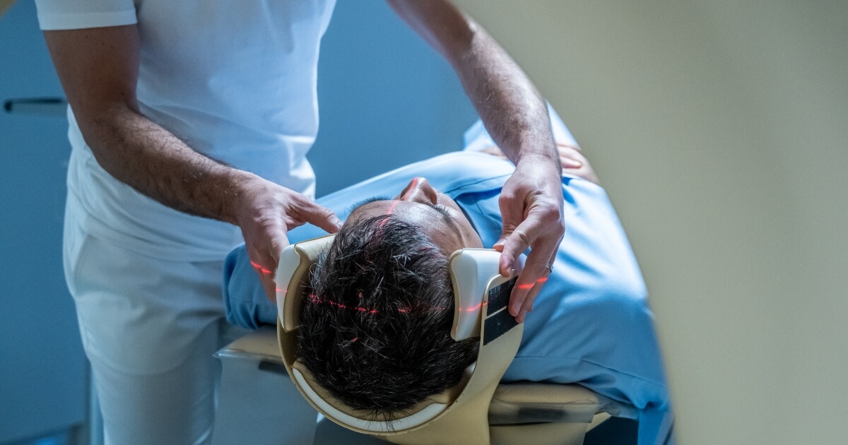 stock image of a male patient about to get a CT scan of his head